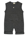 Unisex organic cotton black and white checkered playsuit with a grey pocket in the front and short sleeves. Designer TurtleDove London.