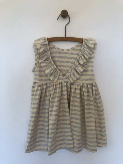 Backside of light grey Vignette dress with wide stripes with ruffles.