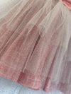 Girls rouge color tulle dress with large wrap around bow. This dress is by Vignette.