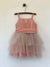 Girls rouge color tulle dress with large wrap around bow and straps. This dress is by Vignette.