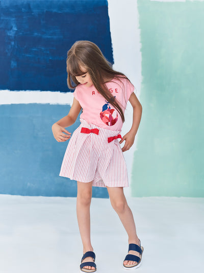 Jean Bourget spring shorts in ecru cotton voile are punctuated with red poppy stripes and enhanced with metallic lurex. Two large folds structure the cut to bring a fluid and light volume.