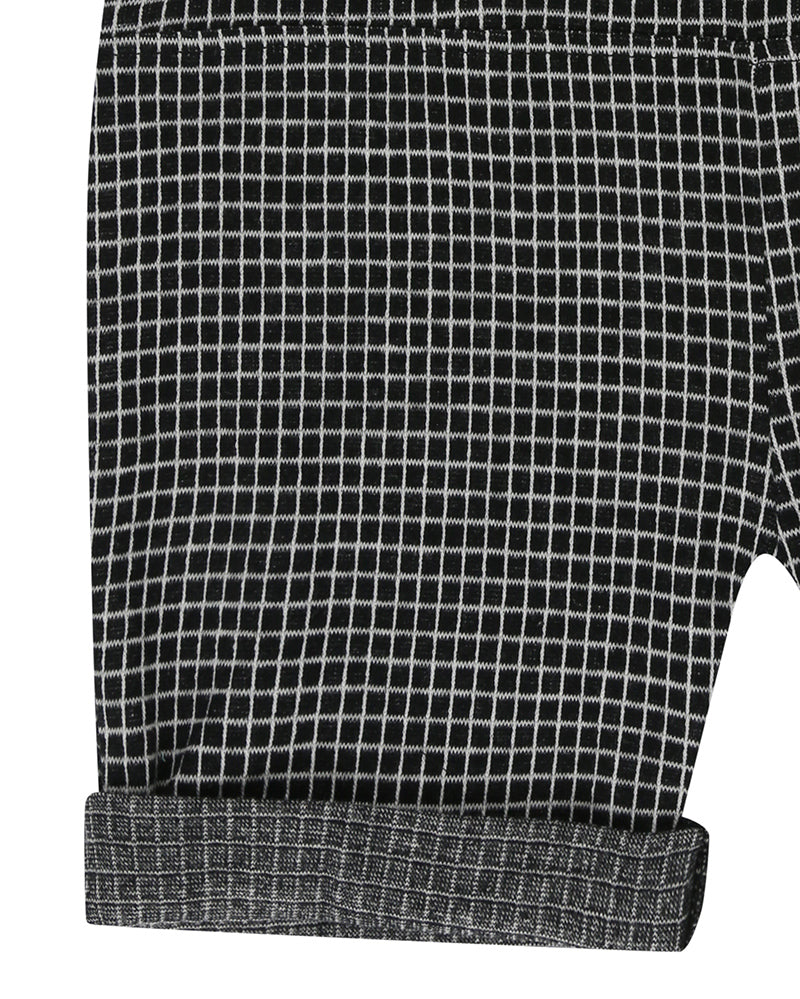 Unisex organic cotton black and white checkered playsuit with a grey pocket in the front and short sleeves. Designer TurtleDove London.