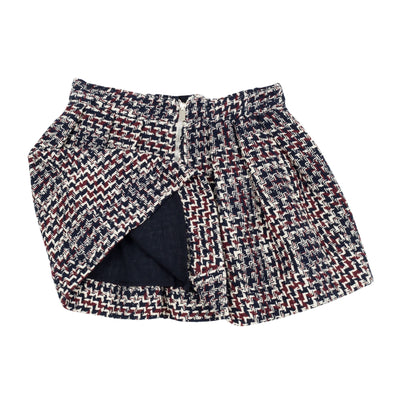 Jean Bourget retro-inspired pleated skirt features a thick navy, plum and ivory check weave. Graphic and trendy, this must have of the season is adorned with a contrasting bow at the neon yellow cord belt.