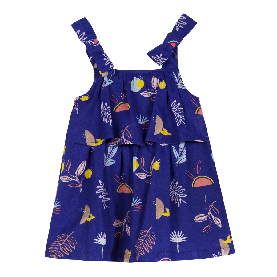 Ultramarine cotton-crepe dress is printed with a cheerful, exotic pattern of birds and tropical plants all over. Designed by Jean Bourget.