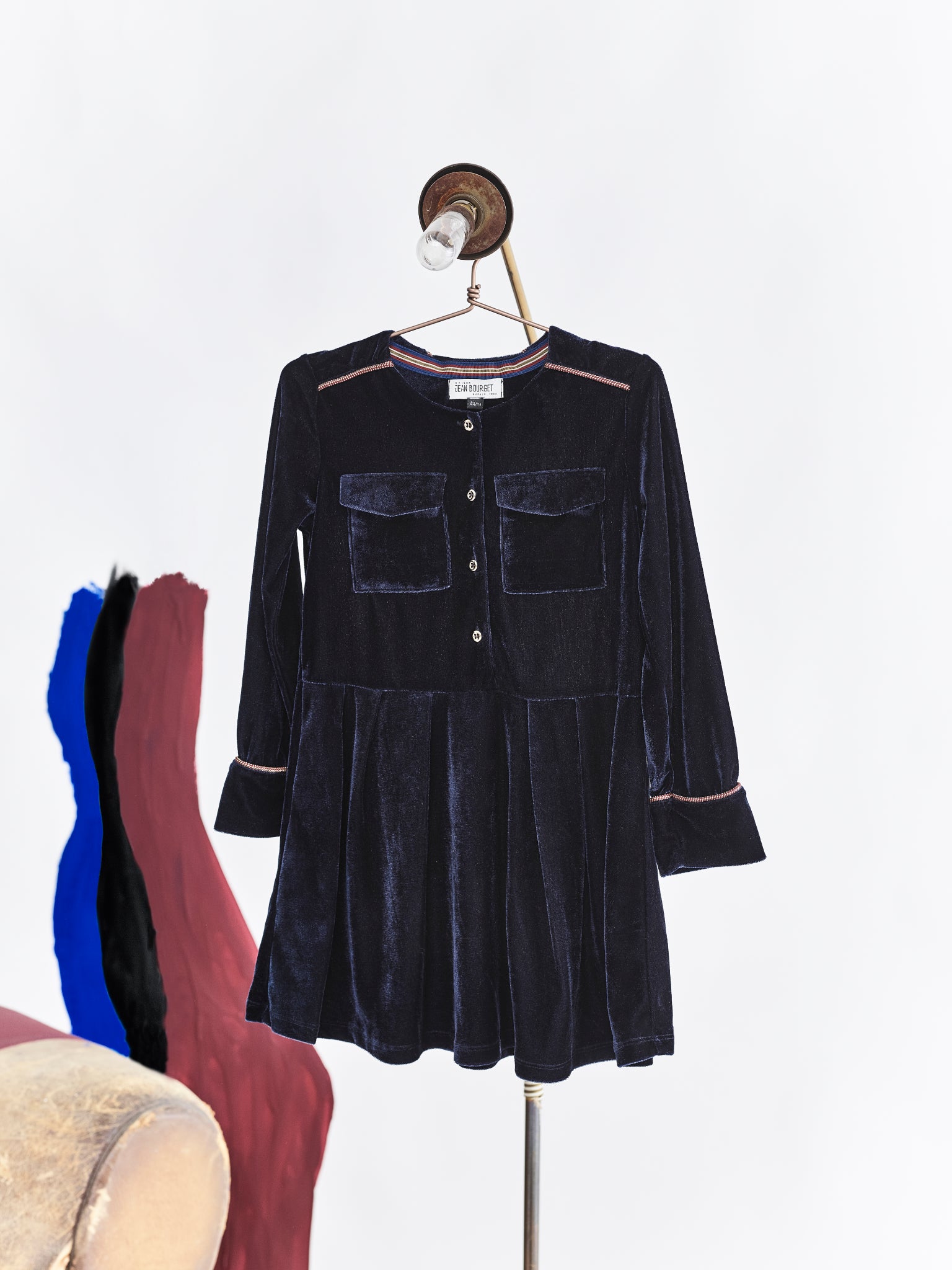 Jean Bourget navy velvet dress with round neck and long sleeves embellished with chic details: burgundy and gold stripes at the neckline and cuffs, 2 pockets in front.