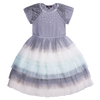 Ballerina tulle dress for girls with rhinestones decreeing the neckline and multilayered skirt with shoes of blues and grey. Image is the designer.
