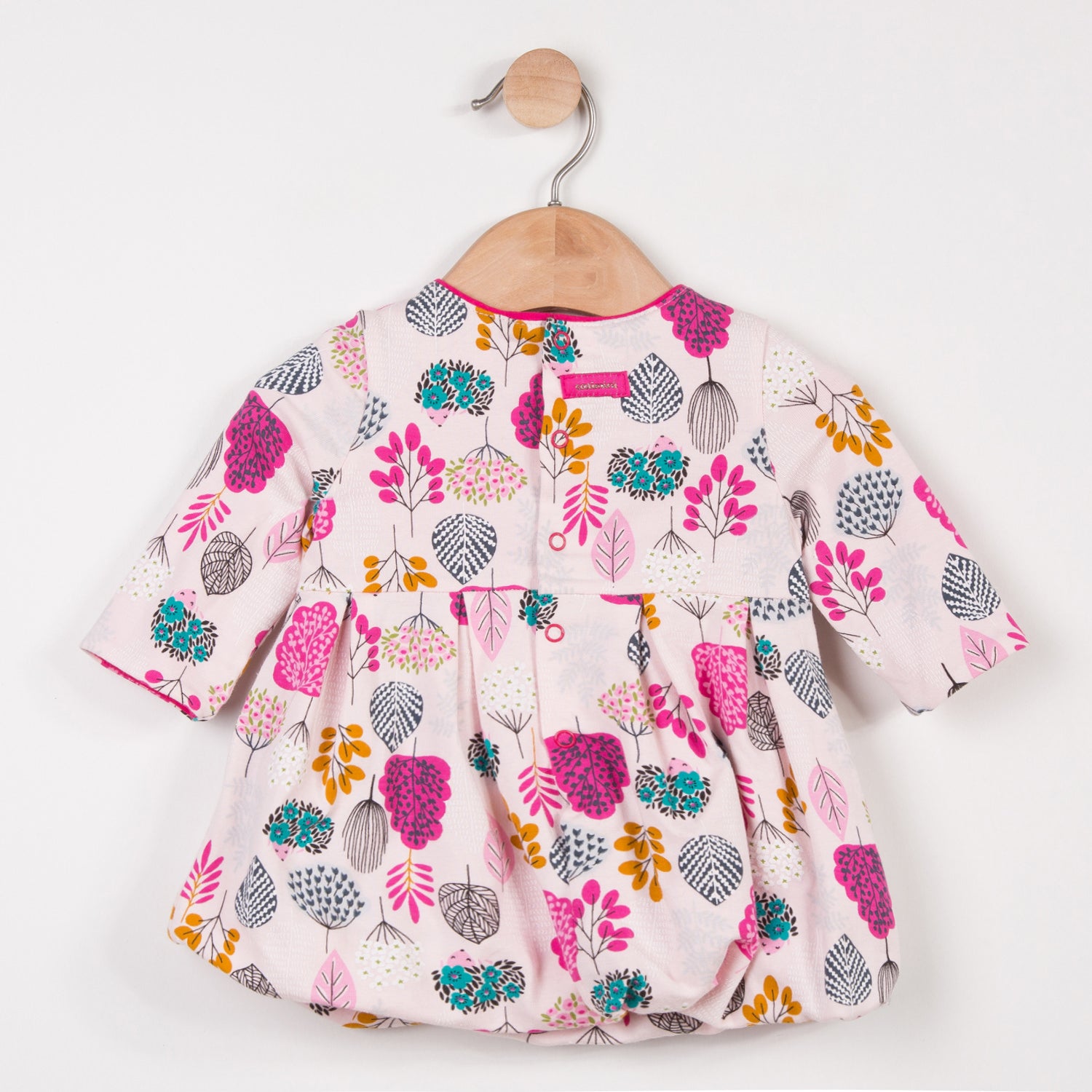 Long sleeved bubble dress in Catimini traditional prints. Stretch jersey with charming floral print in pink tones. Round neckline and stud back fastening.