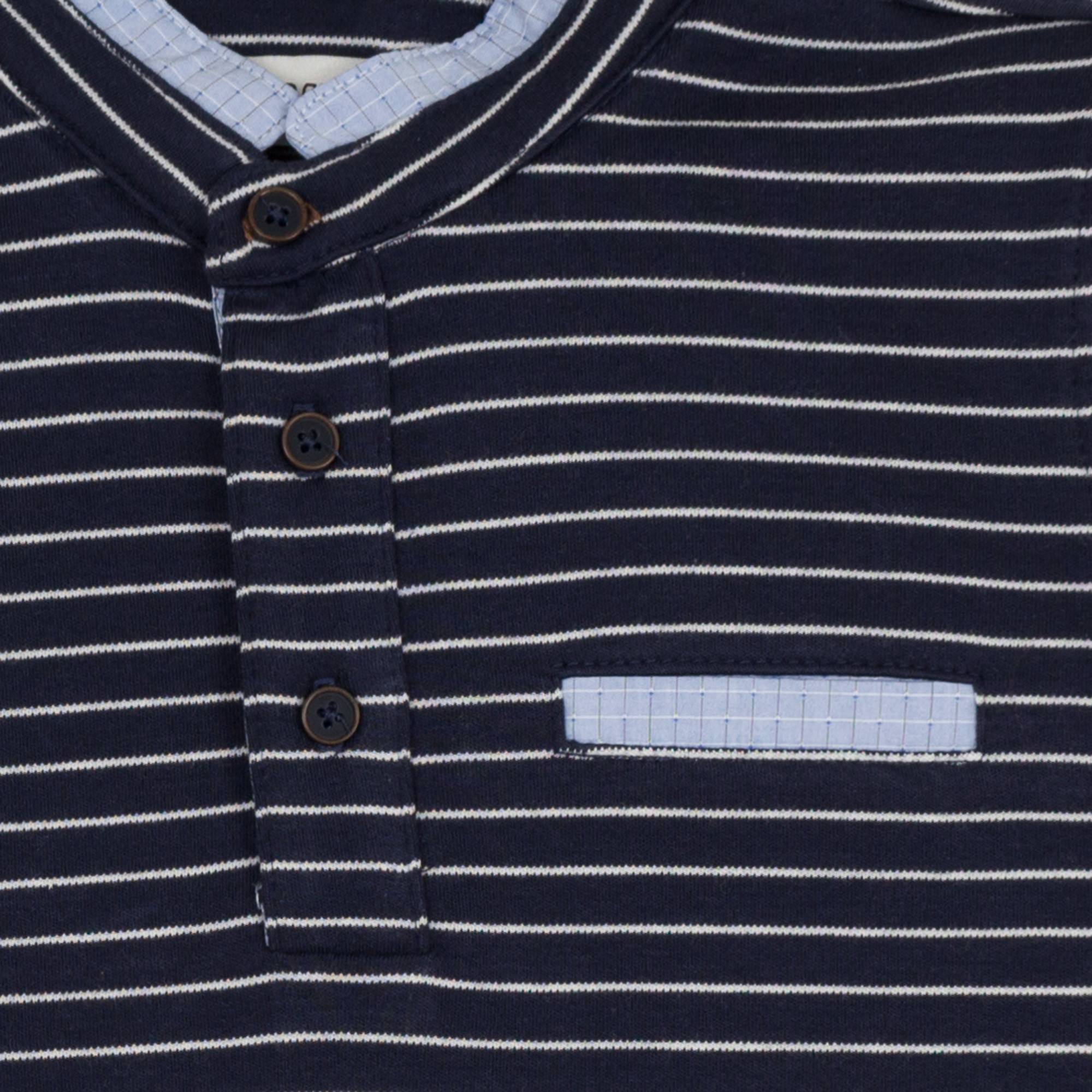 Jean Bourget navy blue long-sleeved polo shirt is punctuated with a sailor stripe. This classic look is twisted by a piped collar of light blue check fabric, matchin