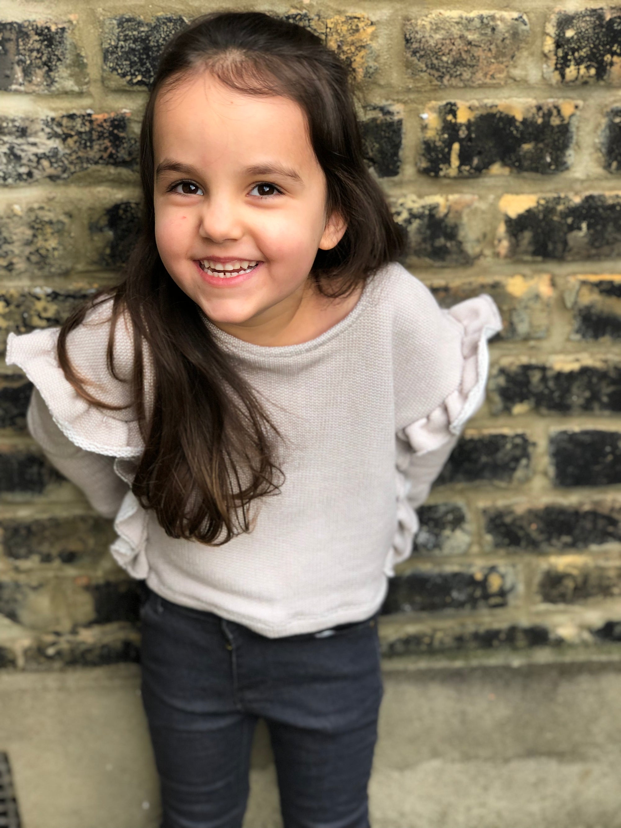 100% cotton top in grey outlined with ruffles down both sides. Designed by Vignette.