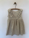 Backside of light grey Vignette dress with wide stripes with ruffles.