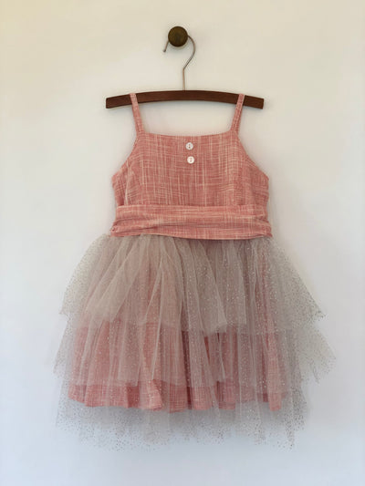 Girls rouge color tulle dress with large wrap around bow and straps. This dress is by Vignette.