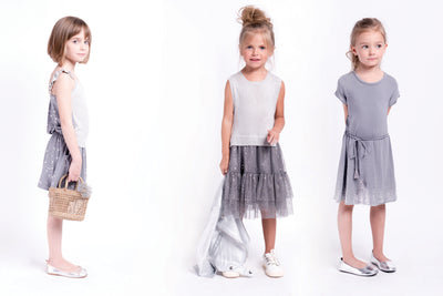Girls sleeveless sweater dress in grey. The top has shimmer and the skirt is polyester with specs of shimmer. Designed by Imoga.