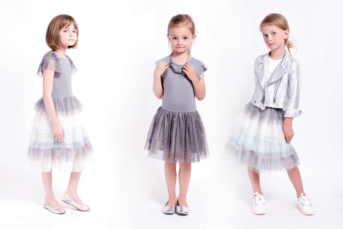 Ballerina tulle dress for girls with rhinestones decreeing the neckline and multilayered skirt with shoes of blues and grey. Image is the designer.