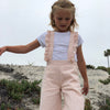 Girls blush color  high waisted overalls with ruffled straps down the back. 100% cotton. Shop Vignette today.