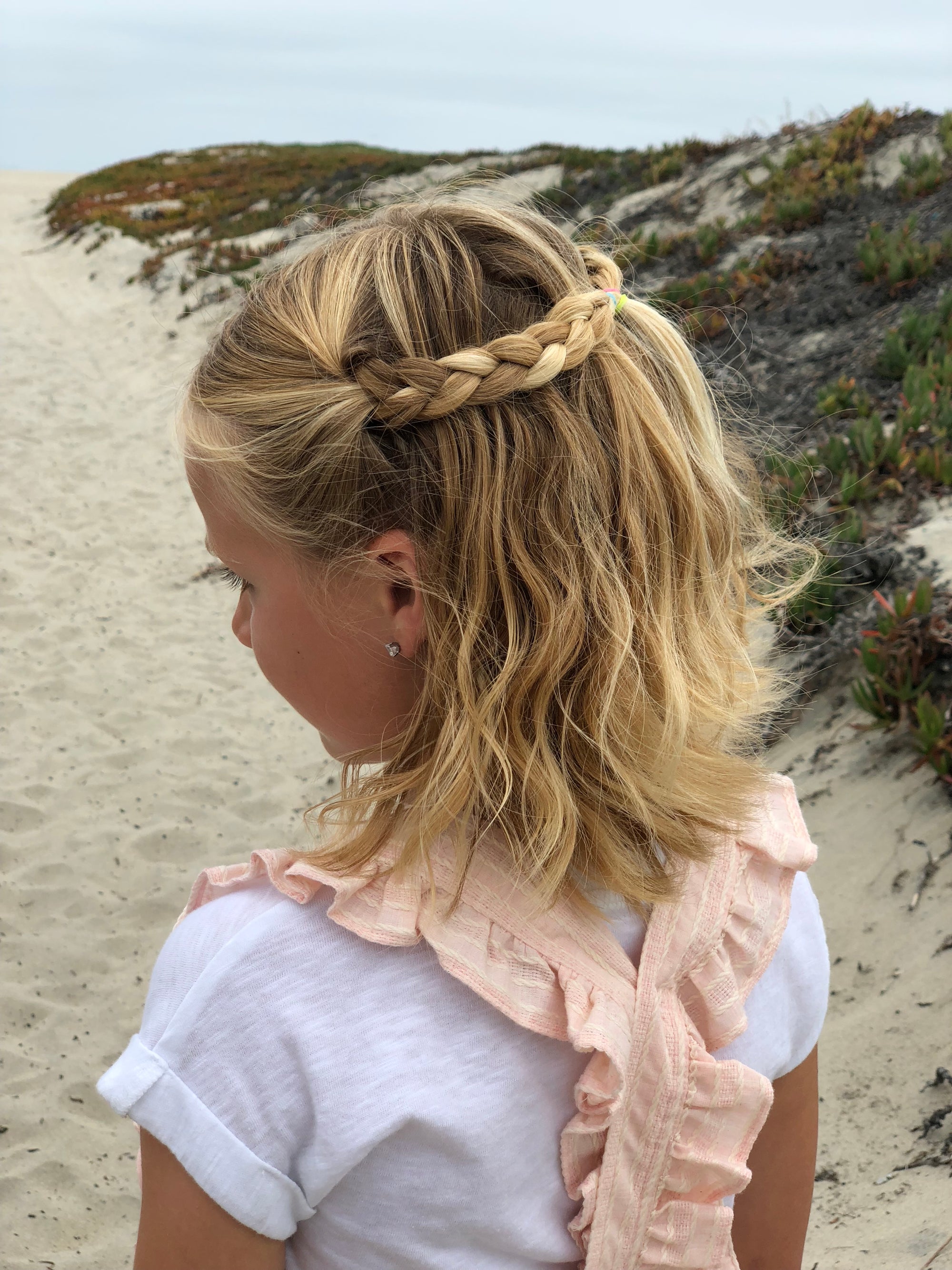 Girls blush color overalls with ruffled straps down the back. 100% cotton. Shop Vignette today.