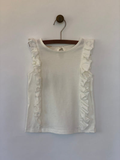 Girls sleeveless ivory tank top with ruffles lining both sides. Shop Vignette for girls.