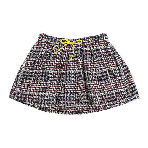 Jean Bourget retro-inspired pleated skirt features a thick navy, plum and ivory check weave. Graphic and trendy, this must have of the season is adorned with a contrasting bow at the neon yellow cord belt.